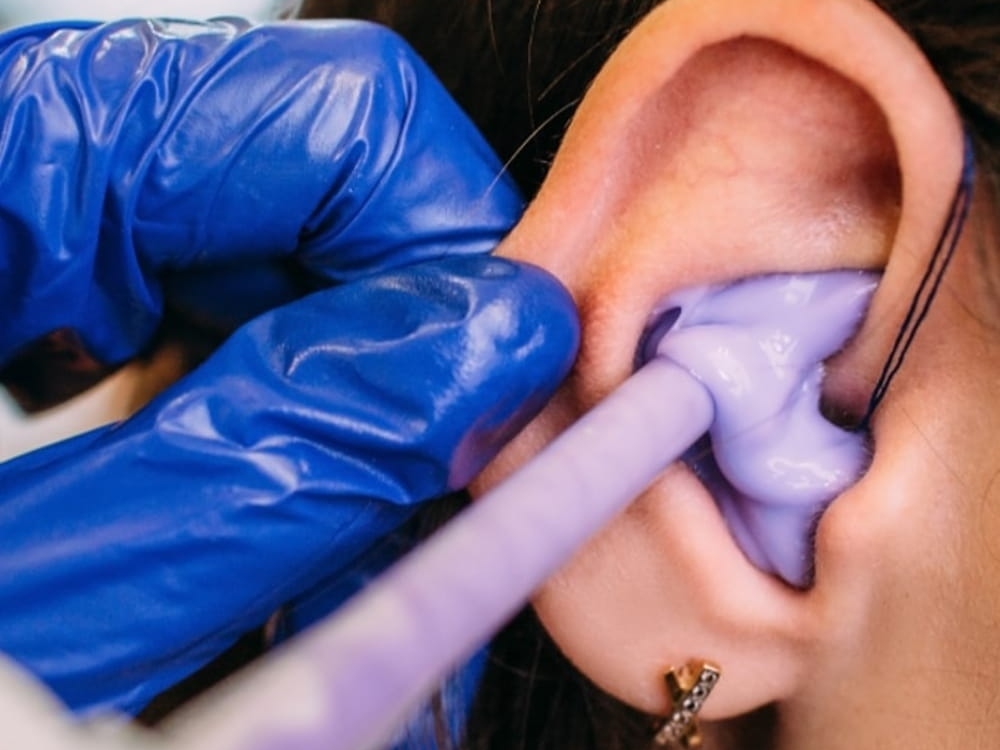 Hearing specialist taking a custom ear impression for hearing protection at Contra Costa Hearing Aid Center in Walnut Creek, CA