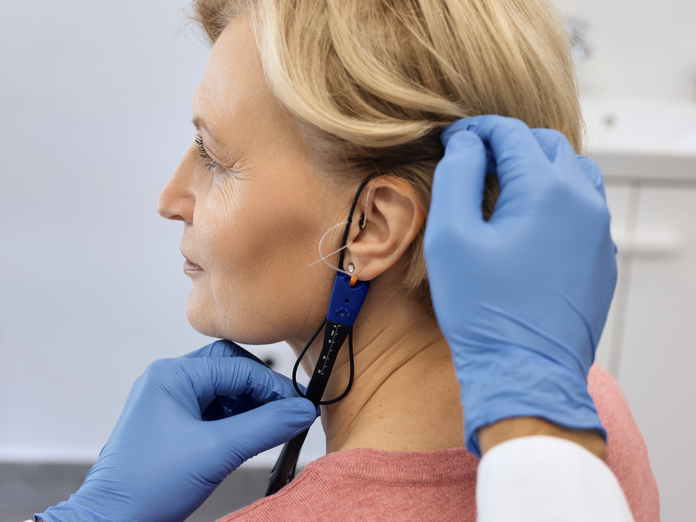 Hearing specialist performing real ear measurement on a hearing aid patient at Contra Costa Hearing Aid Center in Walnut Creek, CA