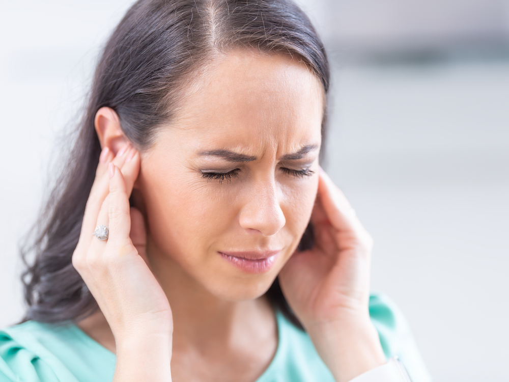 Hearing specialist evaluating a patient for tinnitus and ringing in the ears at Contra Costa Hearing Aid Center in Walnut Creek, CA